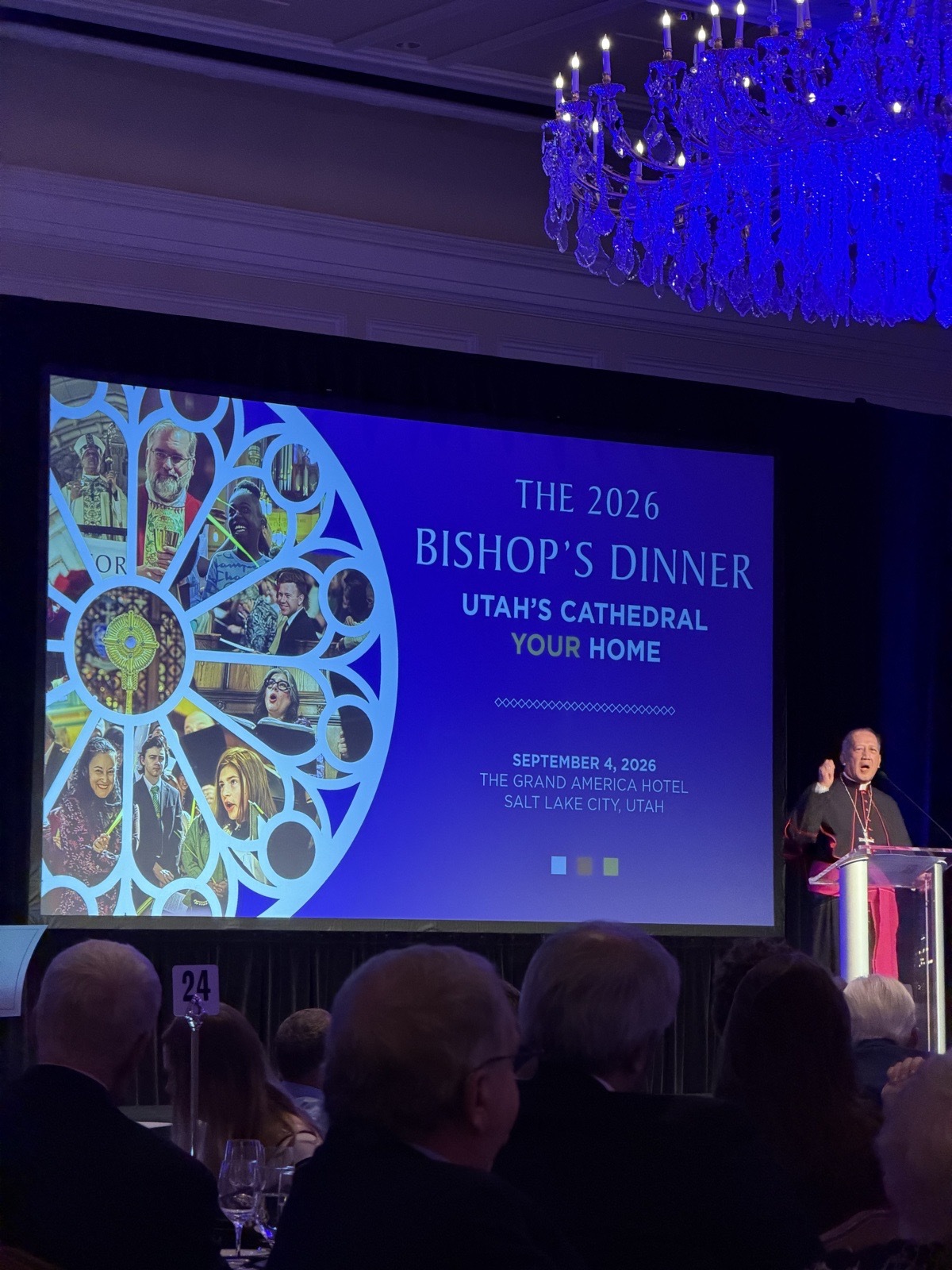 The 2026 Bishop's Dinner title slide — "Utah's Cathedral, Your Home" — with Bishop Solis at the podium